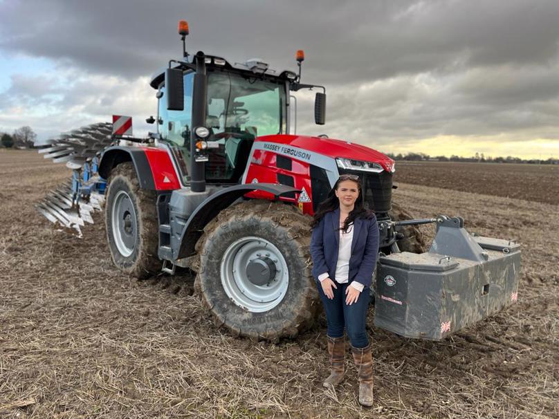 Holly Turner in front of tractor